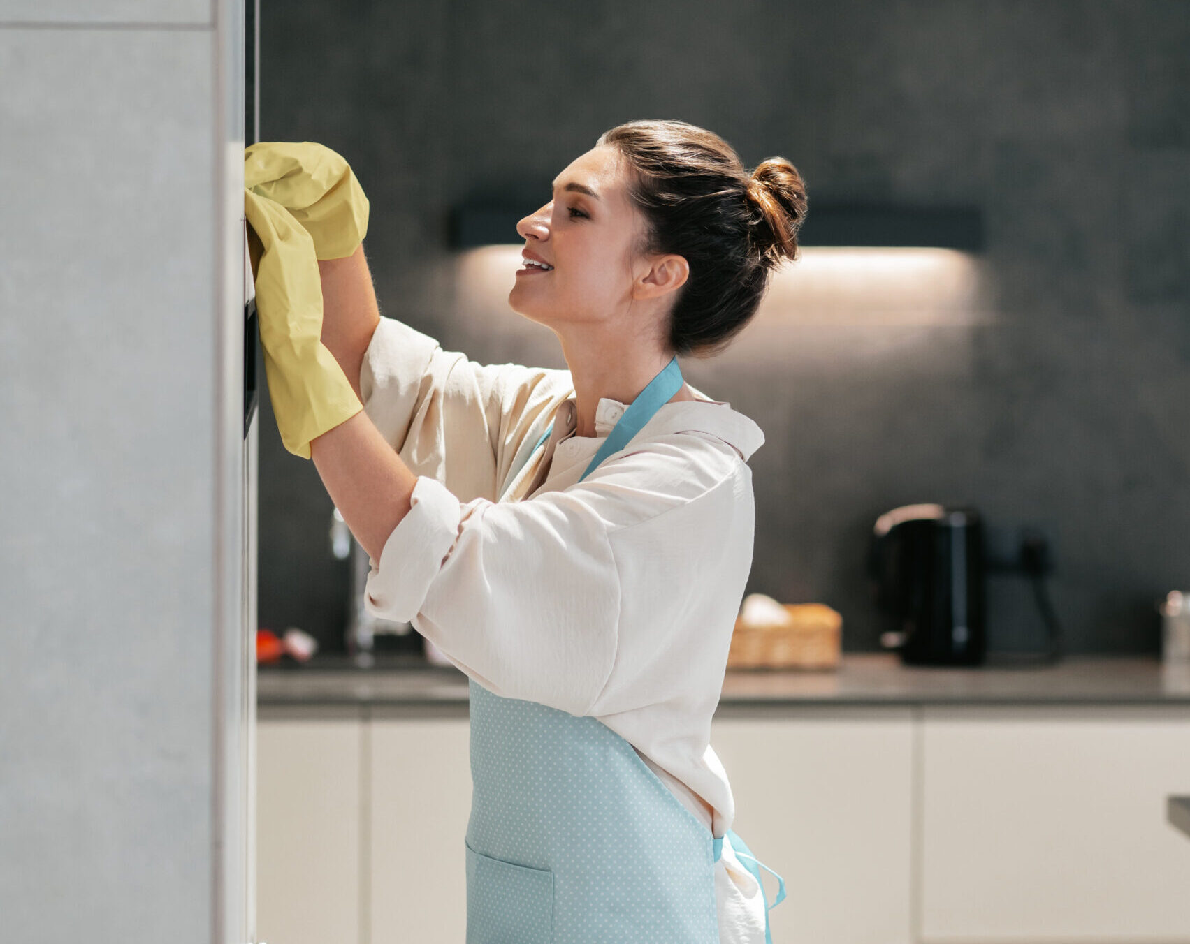 Housework. Young dark-haired woman looking busy while doing housework